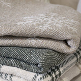 Stack of folded woven blankets with snowflake design