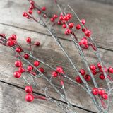 Red faux berries on frosted grey twigs