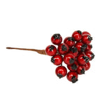 Mini bunch of glossy red holly berries on a wired stem