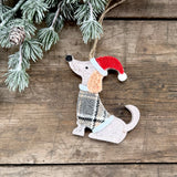 Sitting felt dog decoration in a tartan jacket and Christmas hat