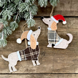 Standing and sitting felt dog decorations in tartan jackets and Christmas hats