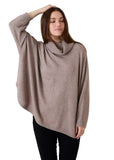 Model wearing the oversized mink mini cable roll neck jumper