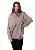 Model wearing the mink mini cable roll neck jumper with black trousers