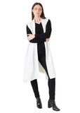 Model wearing the winter white doubleknit roll collar gilet over black, side view