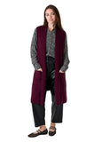 Model wearing the merlot doubleknit roll collar gilet over a patterned blouse
