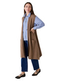 Model wearing the mink doubleknit roll collar gilet over a striped shirt and jeans