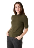 Model wearing the short sleeve knit turtleneck in olive, side view
