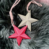 Red and sage green wooden stars with jute hanging loops