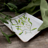 Square stoneware plate with green mistletoe design, additional view