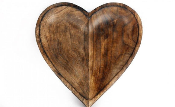 Wooden heart-shaped object on a white background