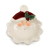 Ceramic Santa face platet with a red hat and holly leaf on a white background
